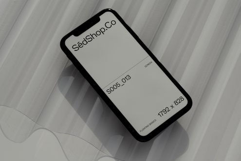 Smartphone mockup on a textured surface with shadows for UI design presentation, suitable for designers looking to showcase their work.